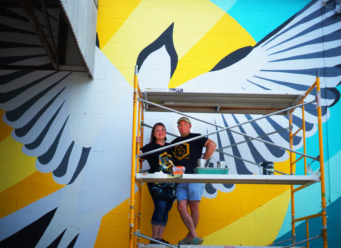 Kelly & Ty Tompkins painting the Oklahoma Phoenix mural at Atelier in Enid, OK